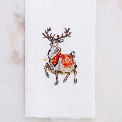 Embroidered reindeer with a red and gold pattern on a white Linen hand towel by Crown Linen Designs