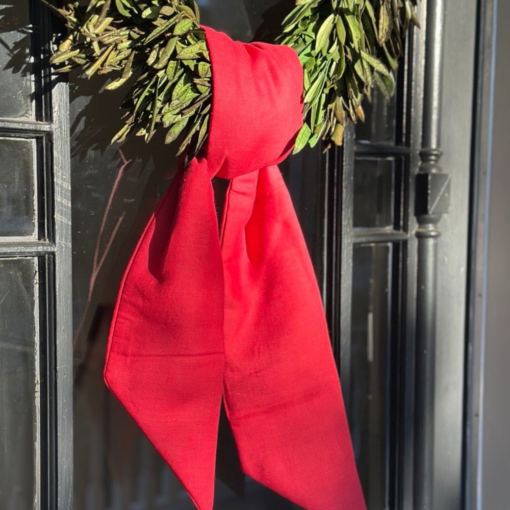 Red bow on a black door with green wreaths
