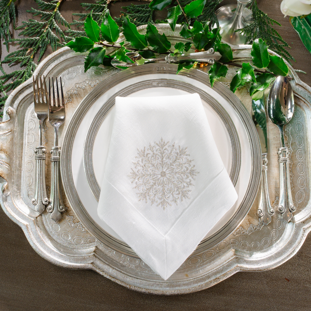 A silver Florentino tray with Tuscan plates and a folded Snowflake Lane Large White Linen Napkin