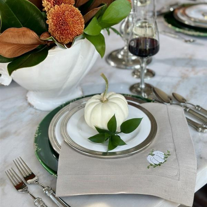 Tuscan Pewter Dinner Plate Table setting with white pumpkin and green leaves.