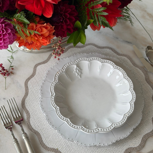 Splendido round placement with Taupe Edge with Bella Bianca Soup Pasta Bowl on a table with Dahlias