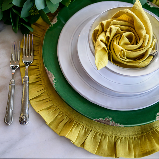Limoncello linen ruffle placemat styled with scavo and firenze plates paired with flatware and flower folded napkin.