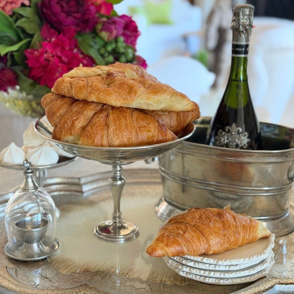 Arte Italica Peltro Pedestal Bowl filled with croissants on a tray with plates for a breakfast meal — Italian pewter