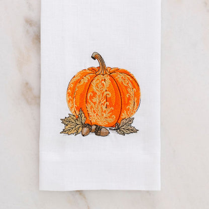Decorative linen towel with a pumpkin design on a marble surface