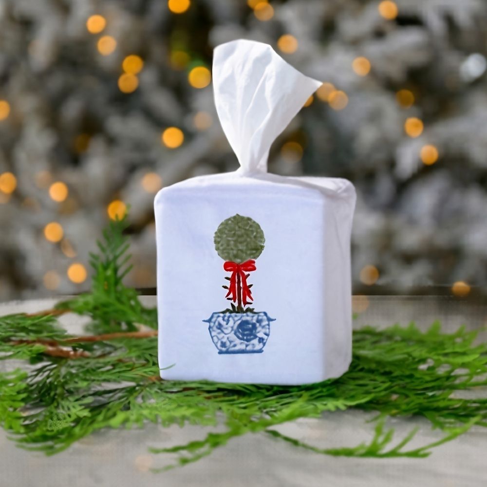 Decorative tissue box cover with a design of La Jardin Bow Topiary against a blurred natural background