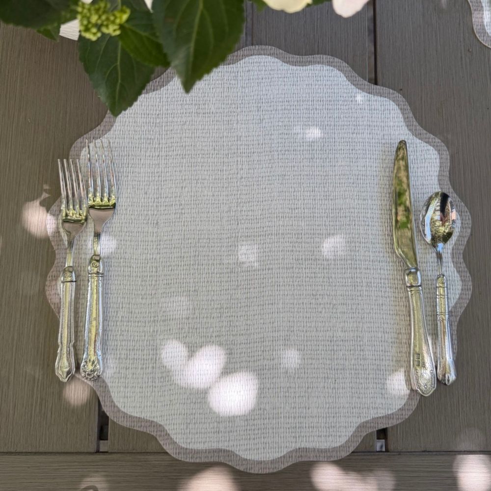 Splendido round wipeable placemat in taupe border styled with elegant cutlery on a natural wood surface — Arte Italica