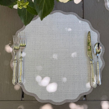 Splendido round wipeable placemat in taupe border styled with elegant cutlery on a natural wood surface — Arte Italica