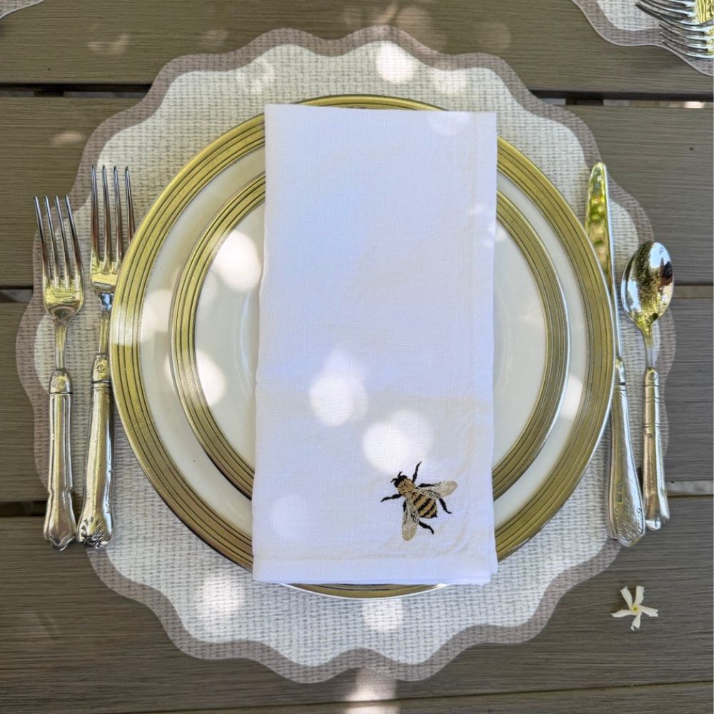 Splendido round wipeable placemat with taupe border, 16-inch diameter, styled on a dining table — Arte Italica