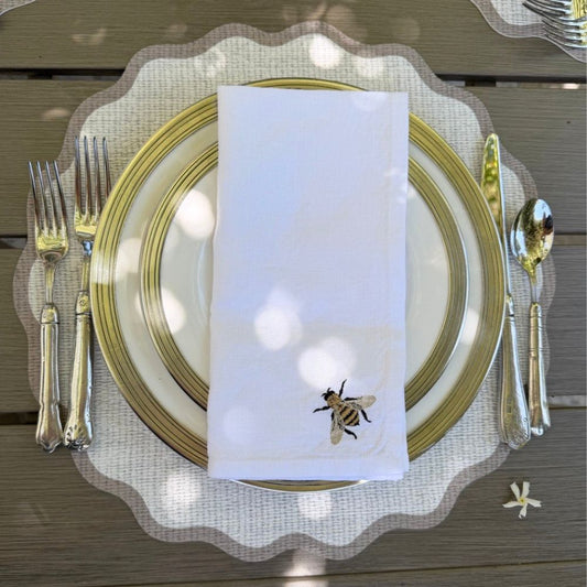 Splendido round wipeable placemat with taupe border, 16-inch diameter, styled on a dining table — Arte Italica