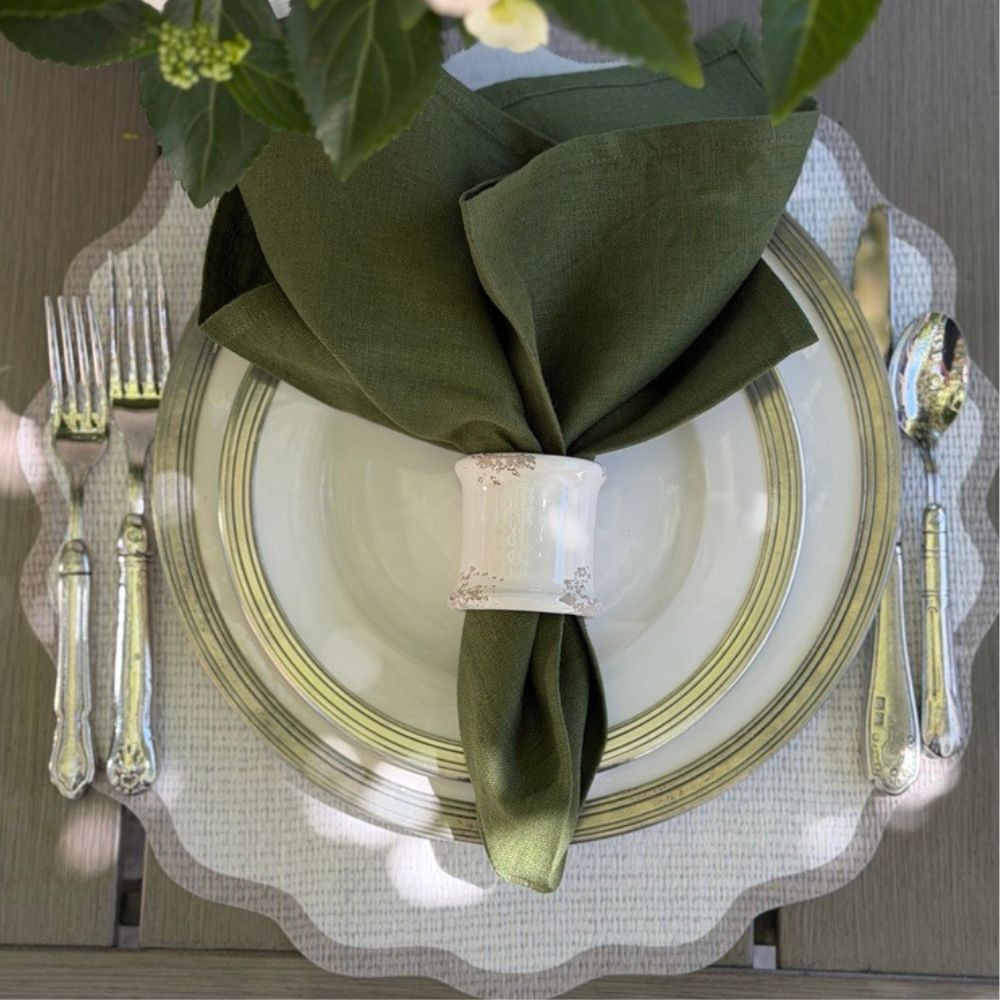 Splendido round wipeable placemat with taupe border styled with green napkin for al fresco outdoor dining — Arte Italica