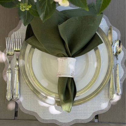Splendido round wipeable placemat with taupe border styled with green napkin for al fresco outdoor dining — Arte Italica