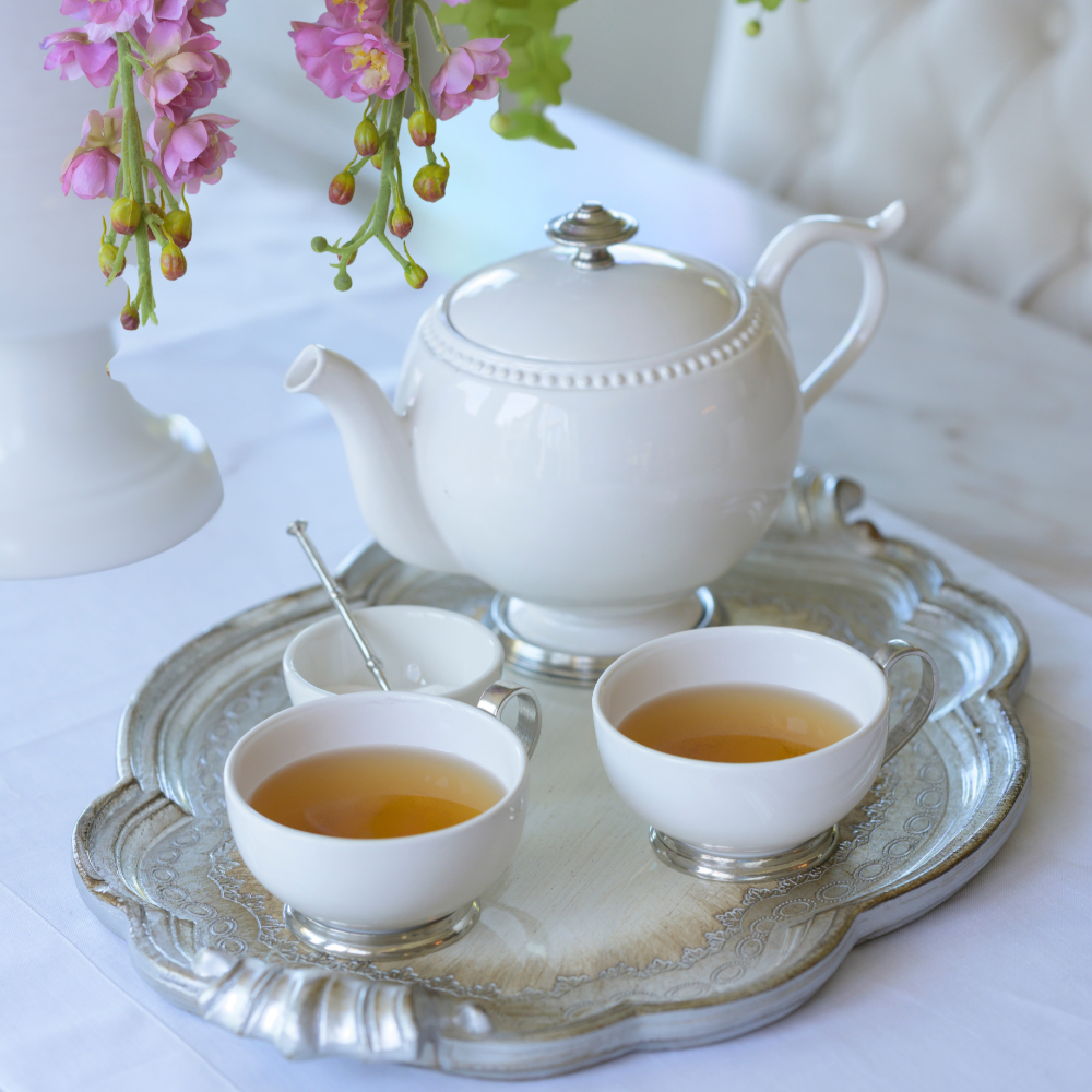 A silver Florentino tray set with a Tuscan beaded ceramic teapot with pewter base and lid handle and 2 coffee cups with tea
