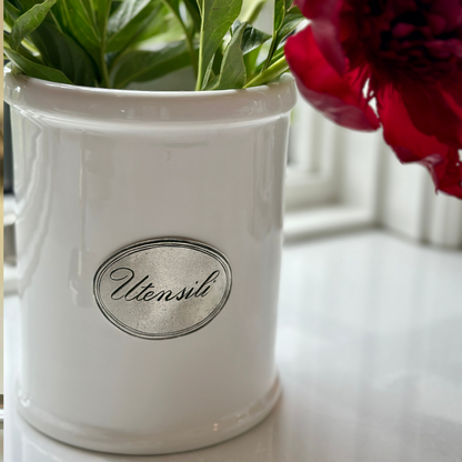 Close up shot of a Tuscan Ceramic Utensil Holder with red flowers