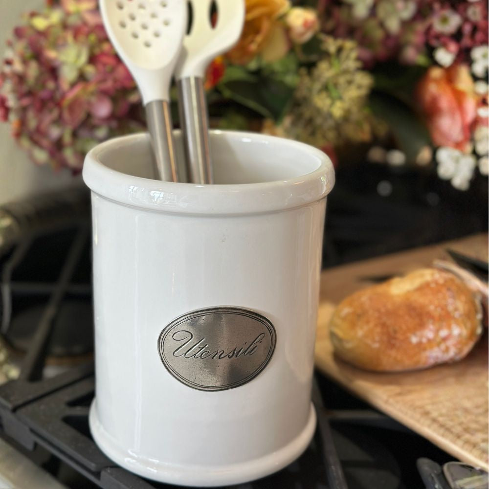 Tuscan Ceramic Utensil Holder on Stove with flowers in the background