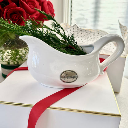 Tuscan Pewter Tab Gravy Boat on a white gift box with greenery and roses in the background