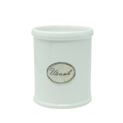 A white ceramic utensil holder with pewter trim and a label on the front that reads 'UTENSILI'.
