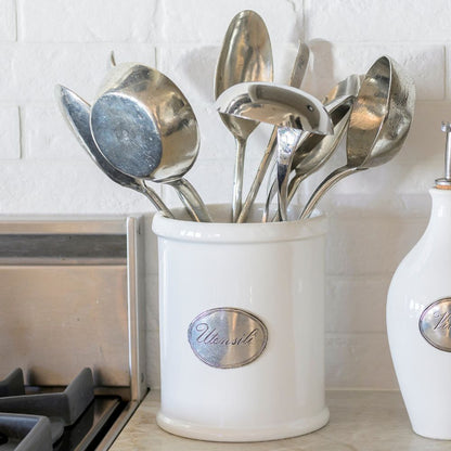 Tuscan ceramic white container with 'Utensil' label on a kitchen counter holding utensils
