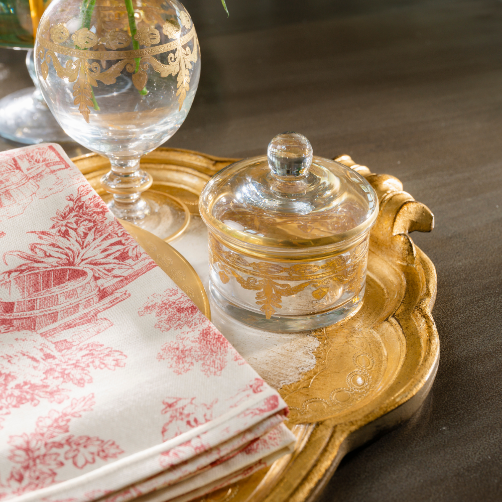 Vetro Gold Covered dish on a Florentino Gold Tray with a Red Montefalco Toile Towel on a table