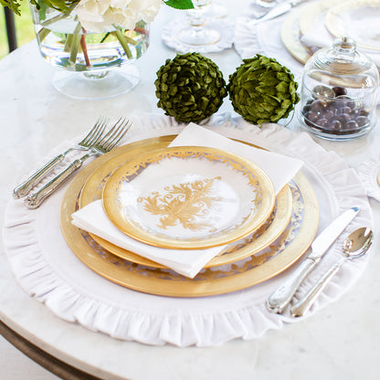  Vetro Gold Charger on a set table with silverware and a white placemat
