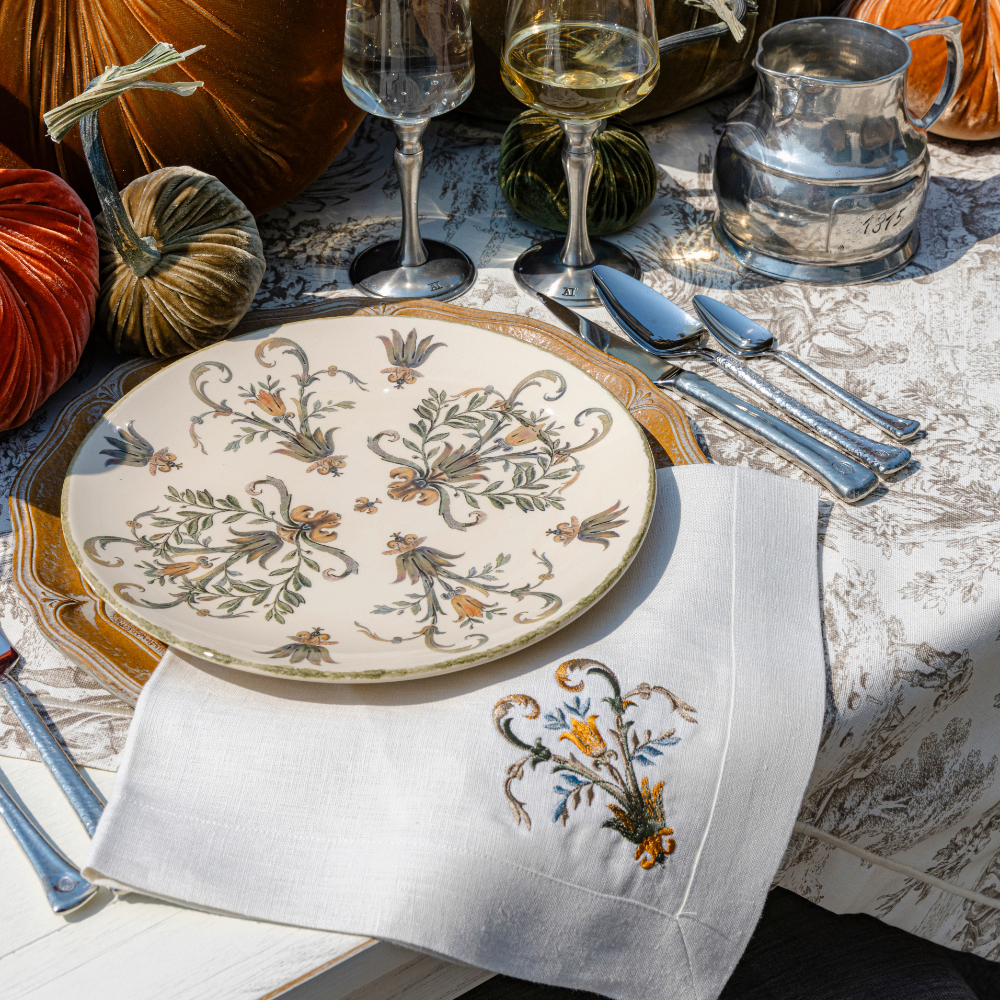 Fall table set with Villa dinner plate on a wooden charger with a Villa Scroll embroidered large linen napkin