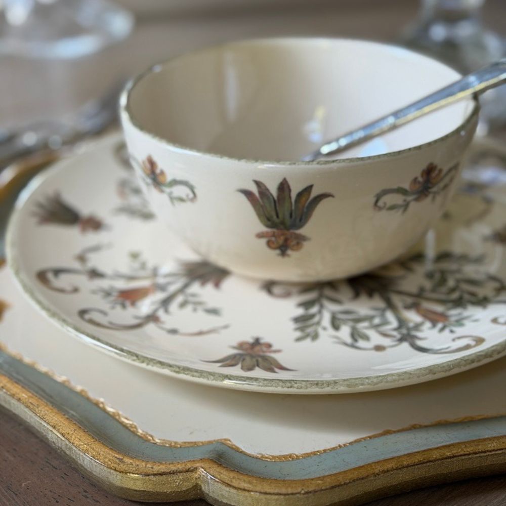 Villa Ceramic Cereal Bowl with spoon on a dinner plate and Florentino Wooden Charger - Arte Italica