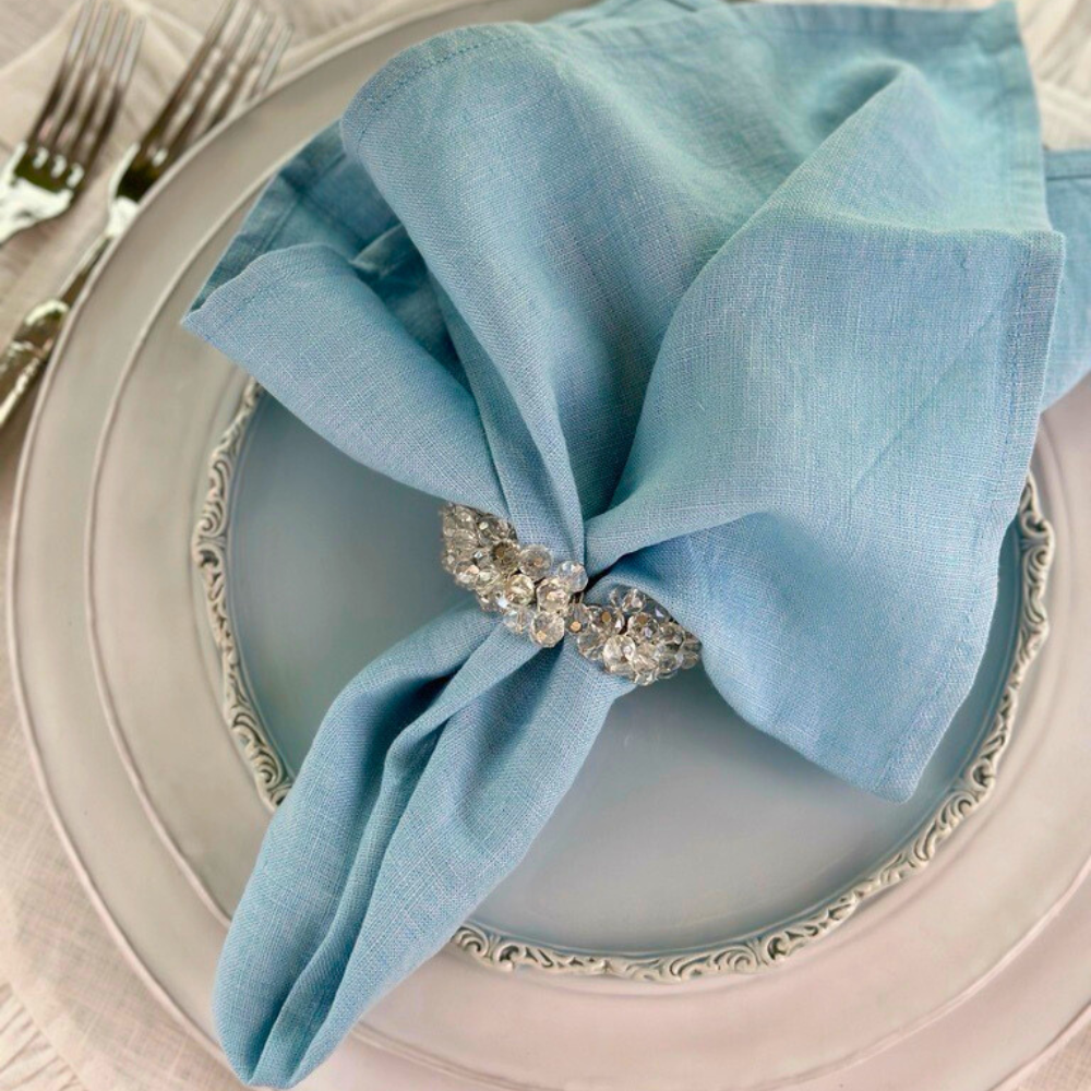 Washed Linen Napkin Set in Light Blue on a blue Imperial Salad Plate - Arte Italica Crown Linen Designs
