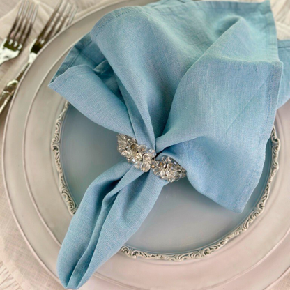 Washed Linen Napkin Set in Light Blue on a blue Imperial Salad Plate - Arte Italica Crown Linen Designs