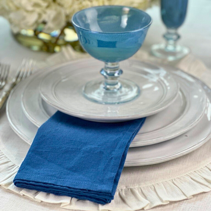 Washed Linen Napkin Set in royal Blue on a white plate  - Arte Italica Crown Linen Designs