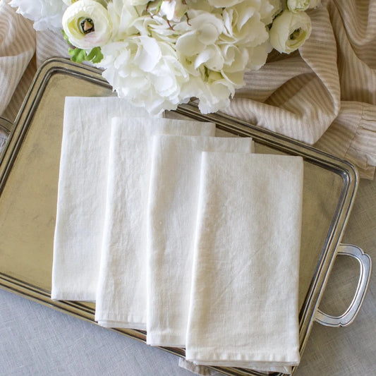 Washed Linen Napkin Set in white displayed on a pewter tray with flowers