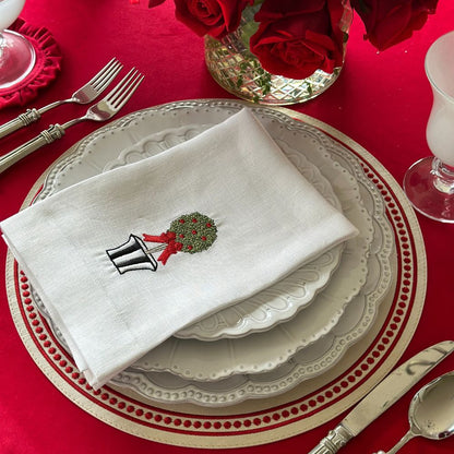 Arte Italica Bella Bianca beaded charger Italian stoneware on red table cloth for holiday dinner and addtional plates