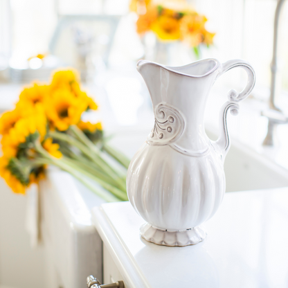 Arte Italica Bella Bianca Italian stoneware pitcher white glaze detail on counter with flowers