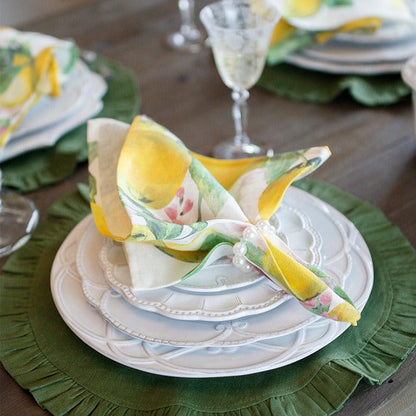 Arte Italica Bella Bianca ribbon charger Italian stoneware with plate stack and italian lemon napkin and green linen placemat