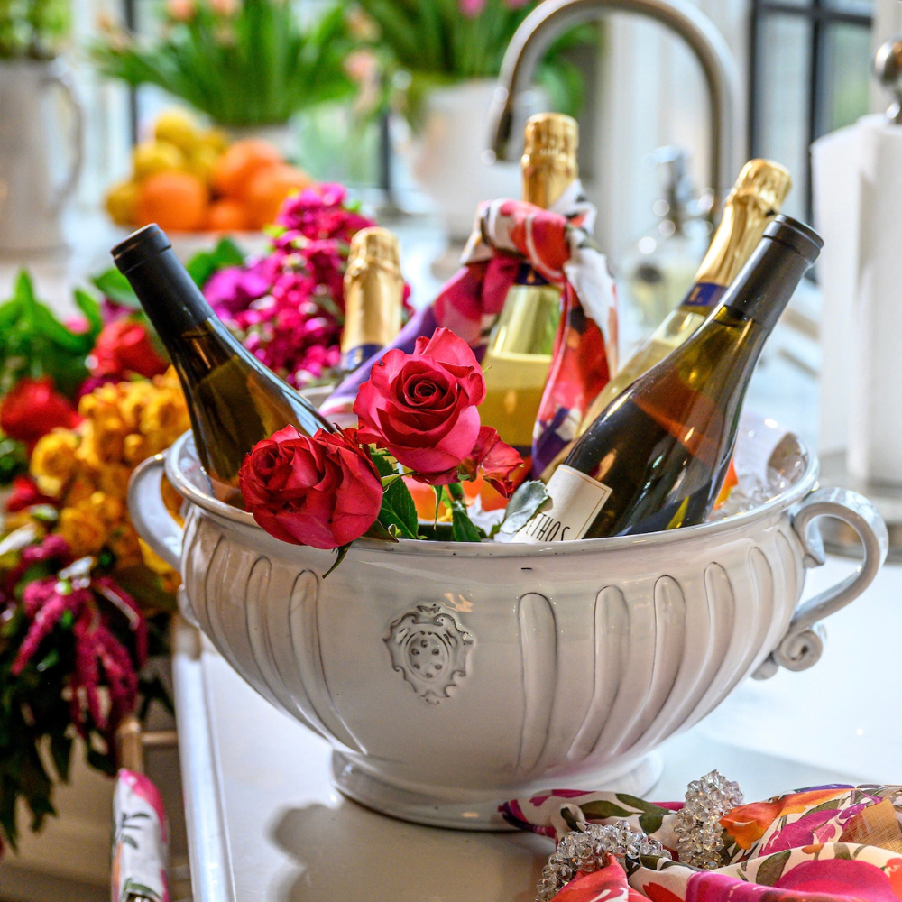 arte italica bella bianca garden urn with wine bottles nested inside and flowers