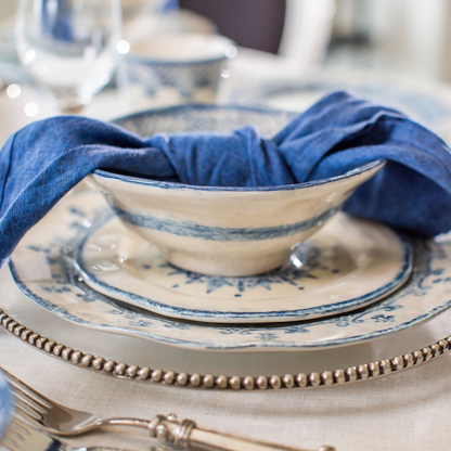 Arte Italica Burano cereal bowl blue ceramic Italian hand painted dinnerware, ceramic breakfast bowl side view with napkin on plates