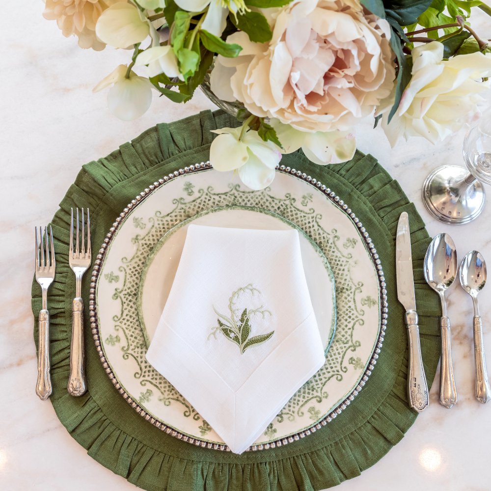 Arte Italica Burano dinner plate green ceramic Italian hand painted dinnerware, decorative table plate overhead view with lily napkin