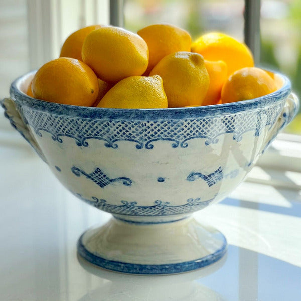 Arte Italica Burano footed bowl with handles blue ceramic Italian hand painted dinnerware with lemons on counter