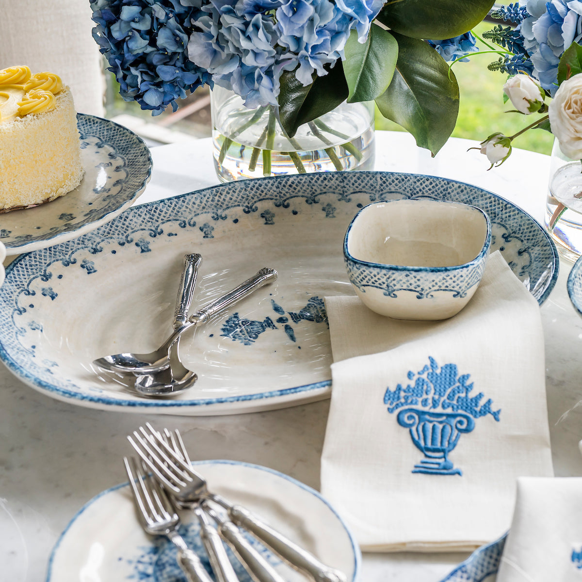 Arte Italica Burano large oval platter blue ceramic Italian hand painted dinnerware, serving platter displayed on table with napkin