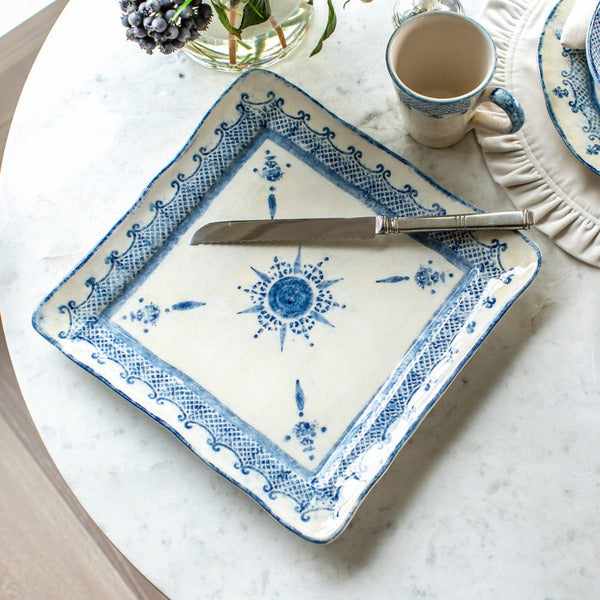 arteitalica-burano-large-square-charger platter-blue-ceramic overhead view with bread knife