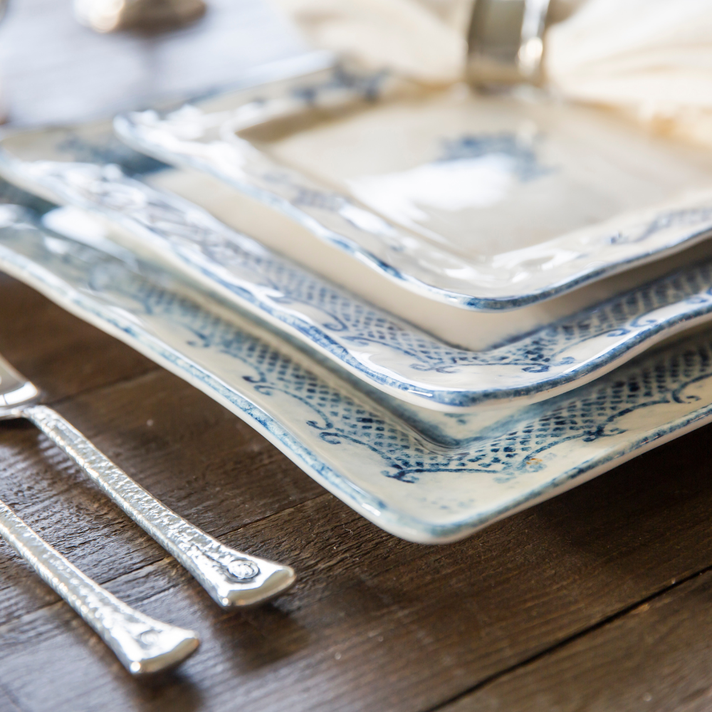 arteitalica-burano-large-square charger blue ceramic Italian hand painted dinnerware, serving platter stack of plates on table