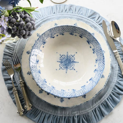 Arte Italica Burano pasta and soup bowl blue ceramic Italian hand painted dinnerware overhead view on table with blue velvet placemat