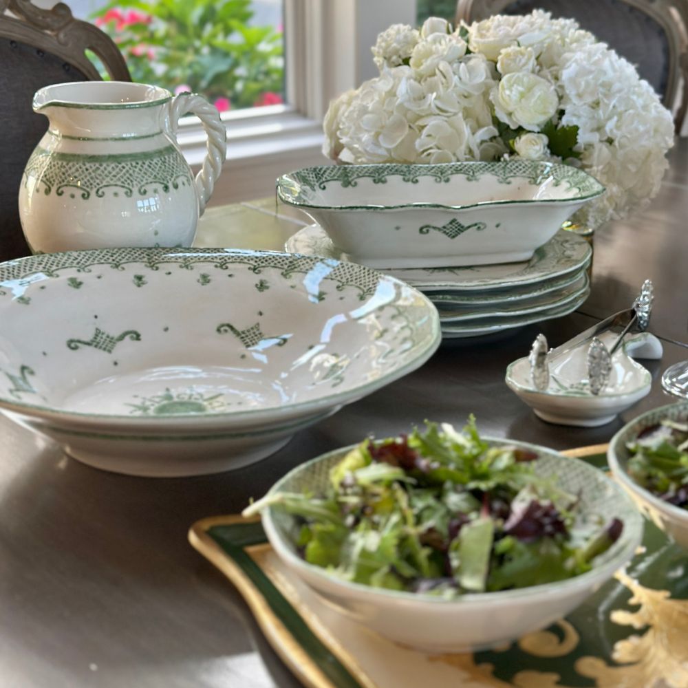 Arte Italica Burano pasta serving bowl green ceramic Italian hand painted dinnerware on display with salads and collection