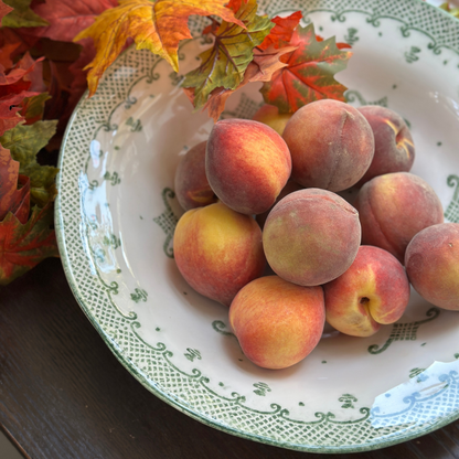 Arte Italica Burano pasta serving bowl green ceramic Italian hand painted dinnerware with peaches in a fall setting