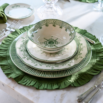 Arte Italica Burano salad and dessert plate green ceramic Italian hand painted dinnerware side view with ceral bowl and plate-charger stack on a linen green placemat