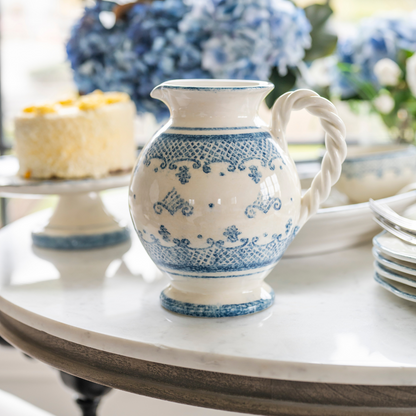 Arte Italica Burano small pitcher blue ceramic Italian hand painted dinnerware side view on table