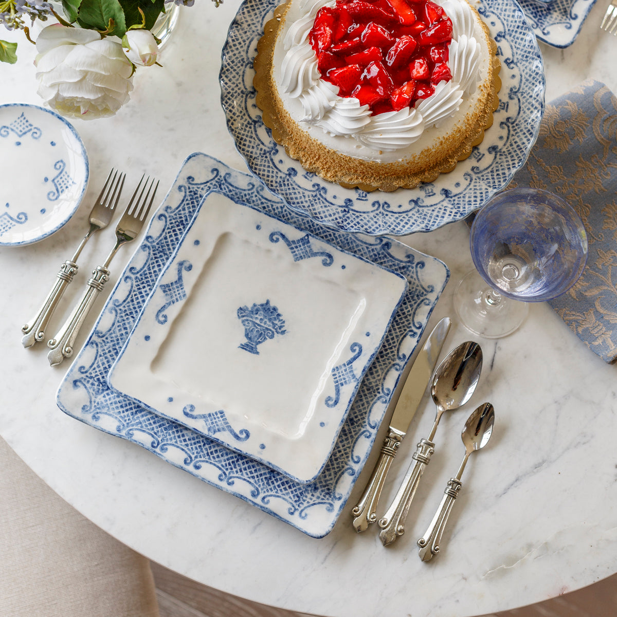 Arte Italica Burano square salad and dessert plate blue ceramic Italian hand painted dinnerware overhead view with cake and flatware