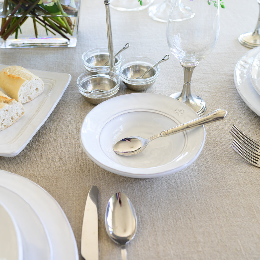 Firenze Cereal Bowl white Italian stoneware handcrafted breakfast bowl with spoon on linen tablecloth