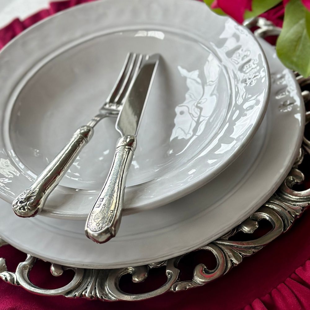 Hotel Collection Fork and Knife on a white Firenze Soup bowl with on a red placemat