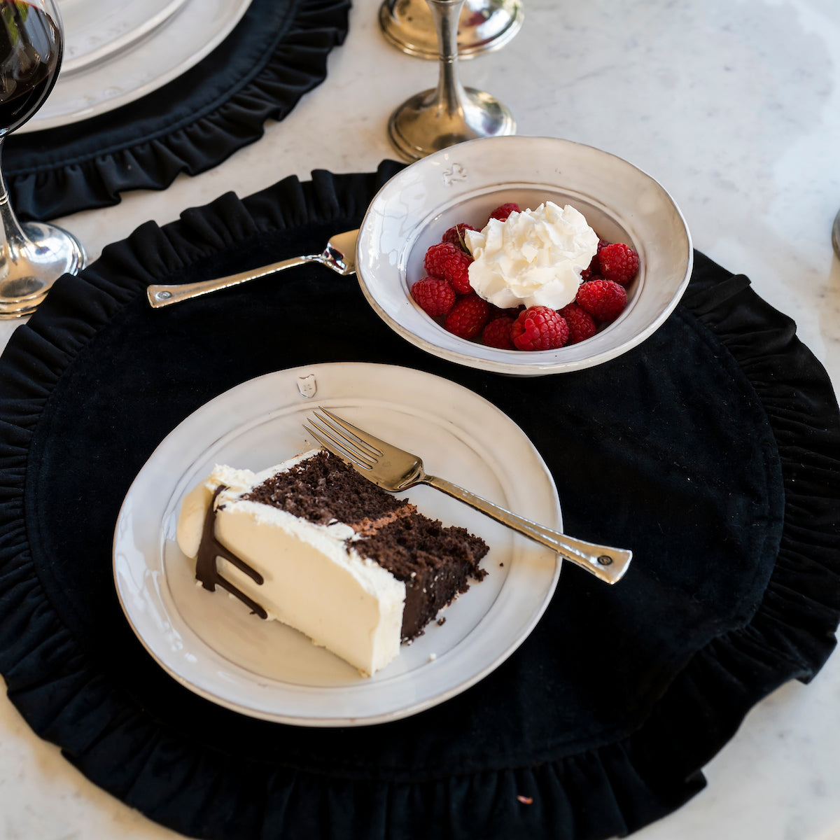 White Firenze Salad Dessert Plate with Chocolate Cake next to Raspberries in a cereal bowl
