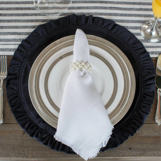 Round Ruffle Velvet Placemat - Two Sizes in navy on a set table with a striped tablecloth
