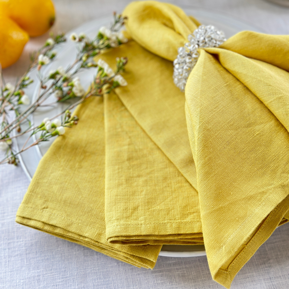 Washed Linen Napkin Set in Limoncello on a white plate with Flowers and Lemon - Arte Italica